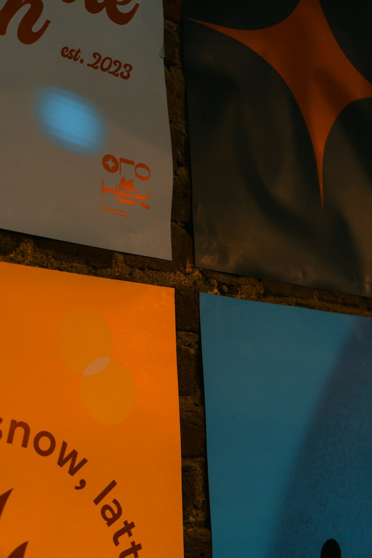 Graphic design and branding posters on a wall
